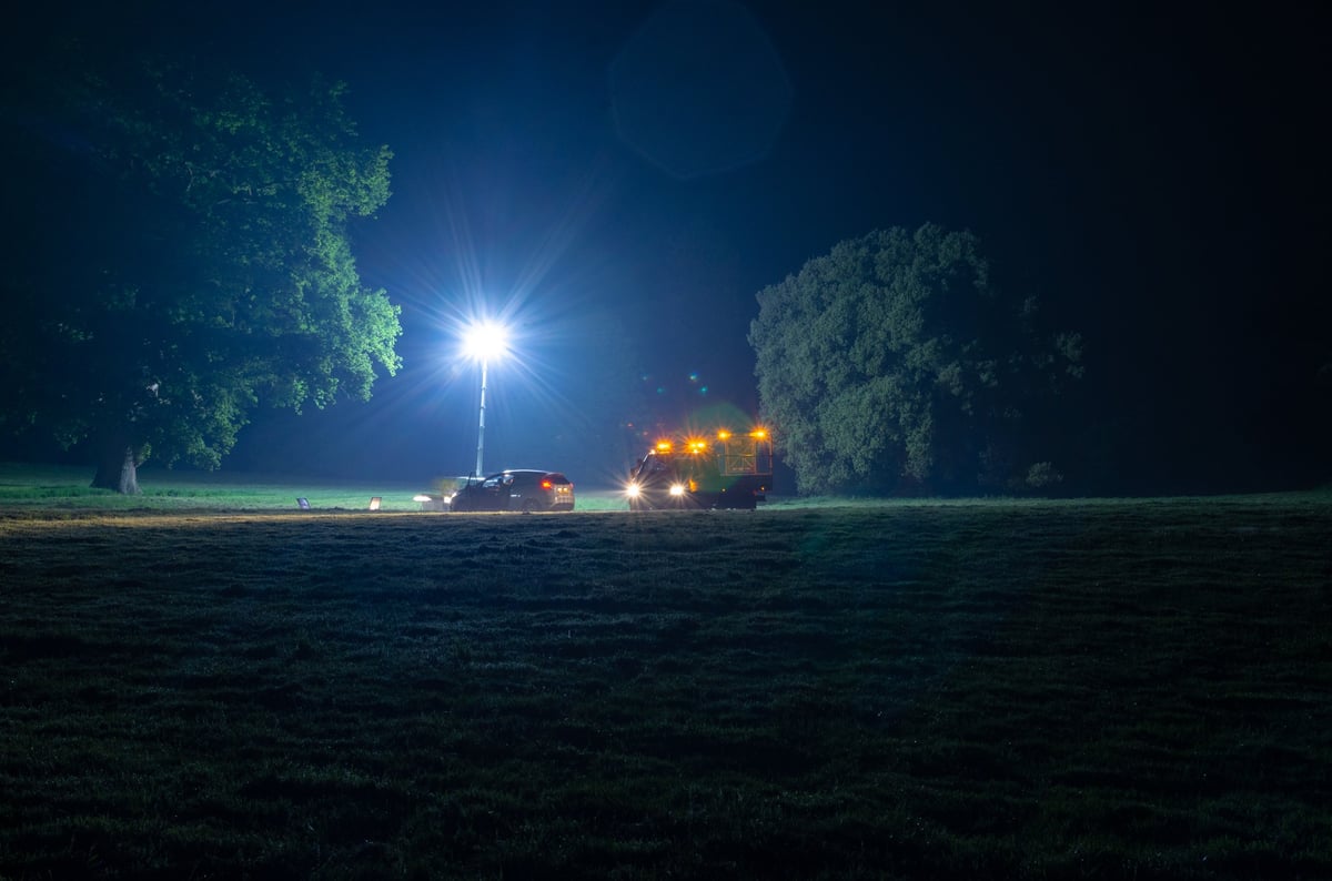 Emergency recovery truck assisting a broken down vehicle during night time