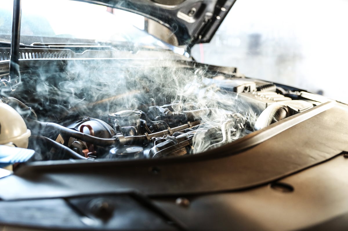 Steam and vapor rising from an overheating car engine in Reston Virginia