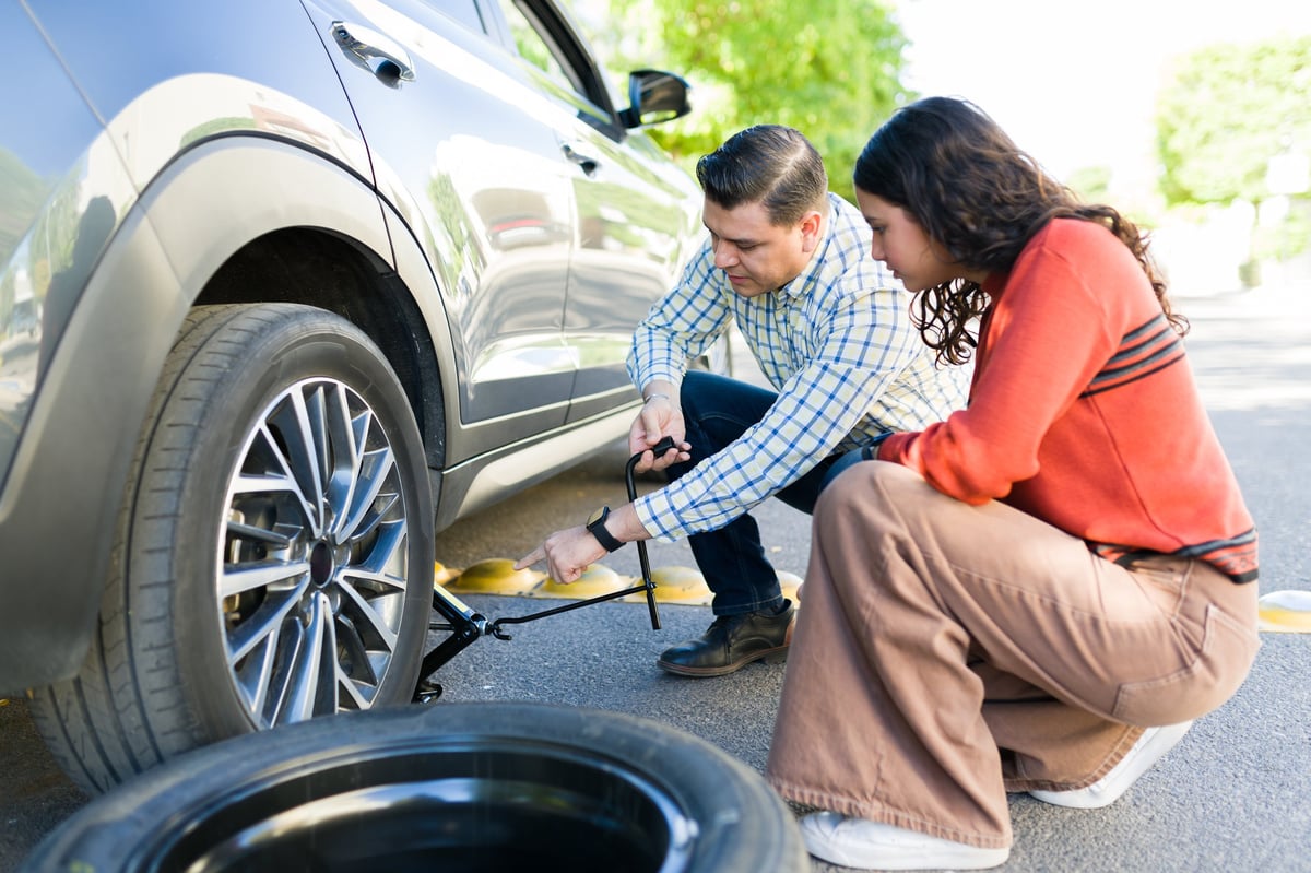Flat tire change near Fair Lakes VA installing a spare tire on the roadside