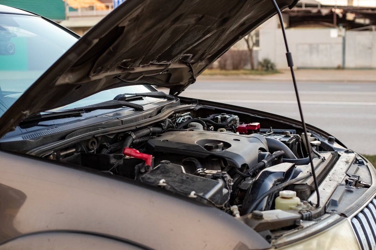 Car breakdown with hood open on the roadway