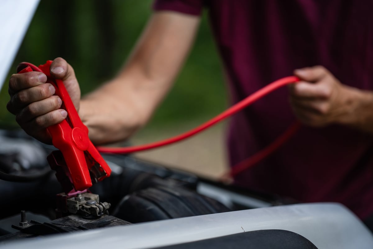 Jump start service in Fairfax Virginia connecting jumper cables to a car battery